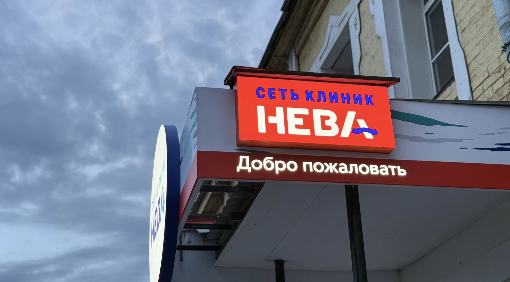 Изготовление и монтаж рекламных козырьков для клиники «Нева» под ключ фото